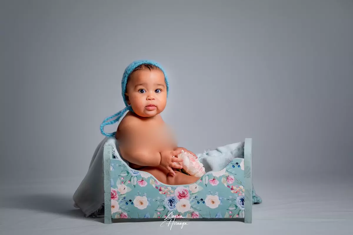Baby in small floral bed
