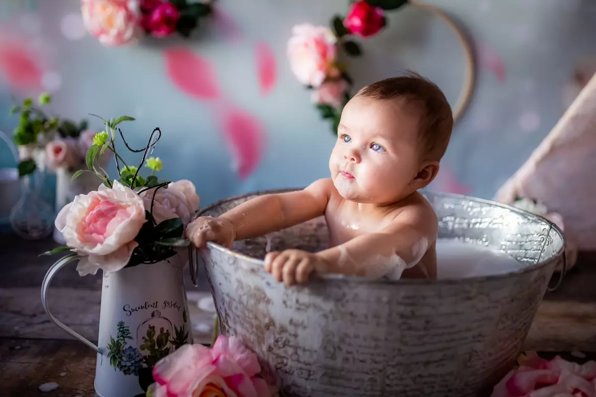 Baby in a tin tub with flowers