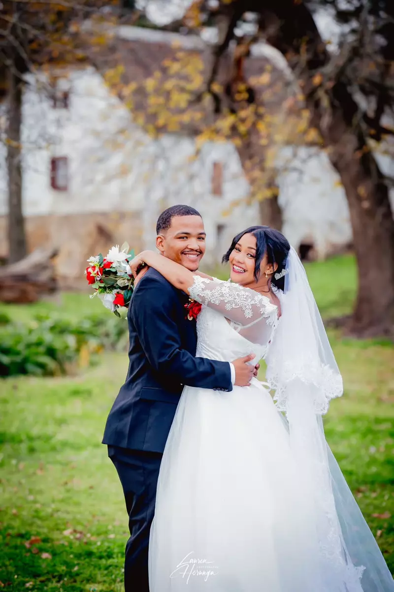 Bride and groom embracing outdoors on their wedding day