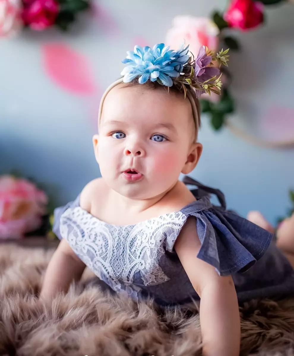 Baby girl in a blue floral dress